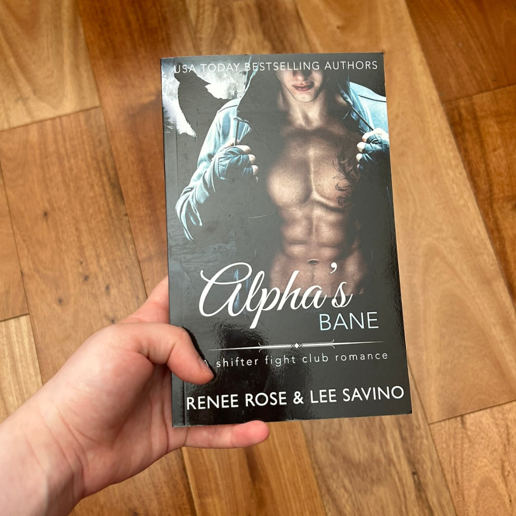 Photo of someone holding a classic Alphas Bane cover paperback