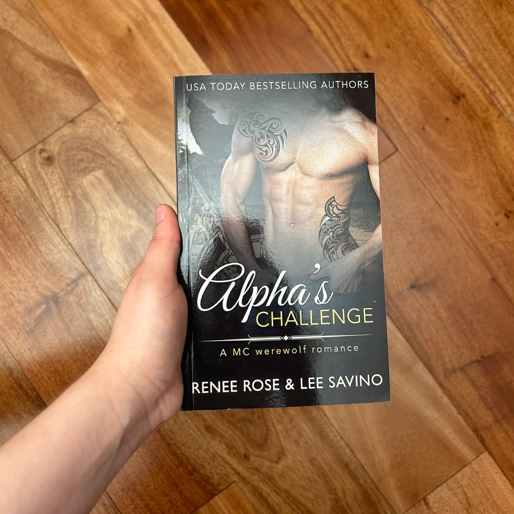 Photo of someone holding a classic Alphas Challenge cover paperback