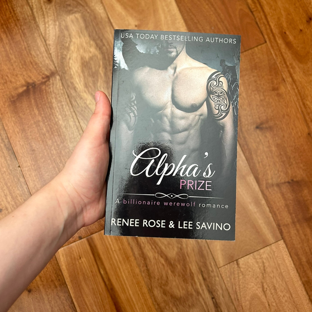 Photo of someone holding a classic Alphas Prize cover paperback