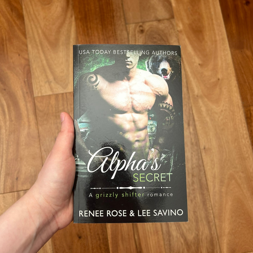 Photo of someone holding a classic Alphas Secret cover paperback