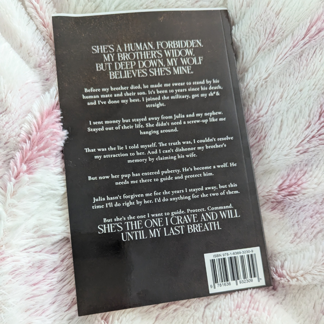 The back of the alternate cover of the "Alpha's Command" paperback. In white text is the book blurb. 