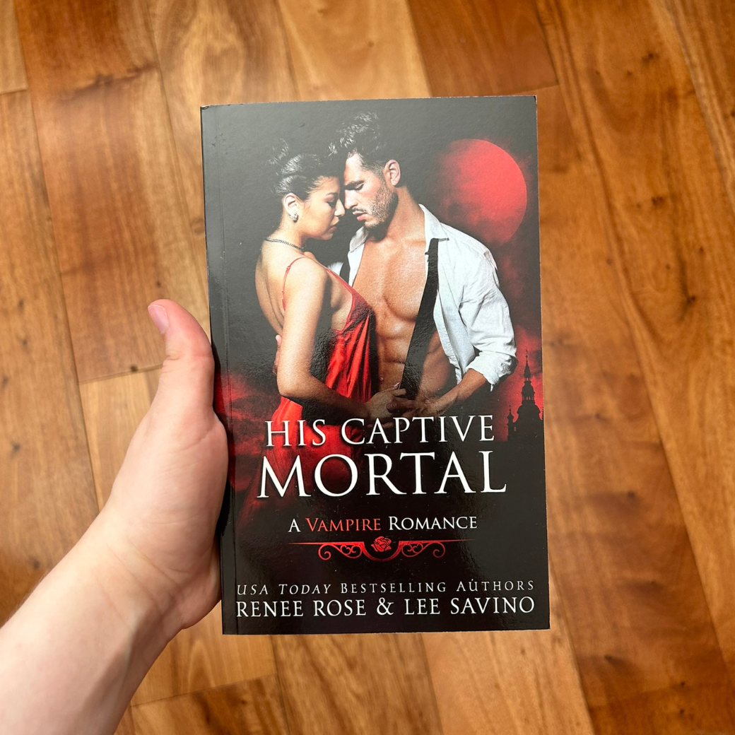 Photo of someone holding a classic His Captive Mortal cover paperback